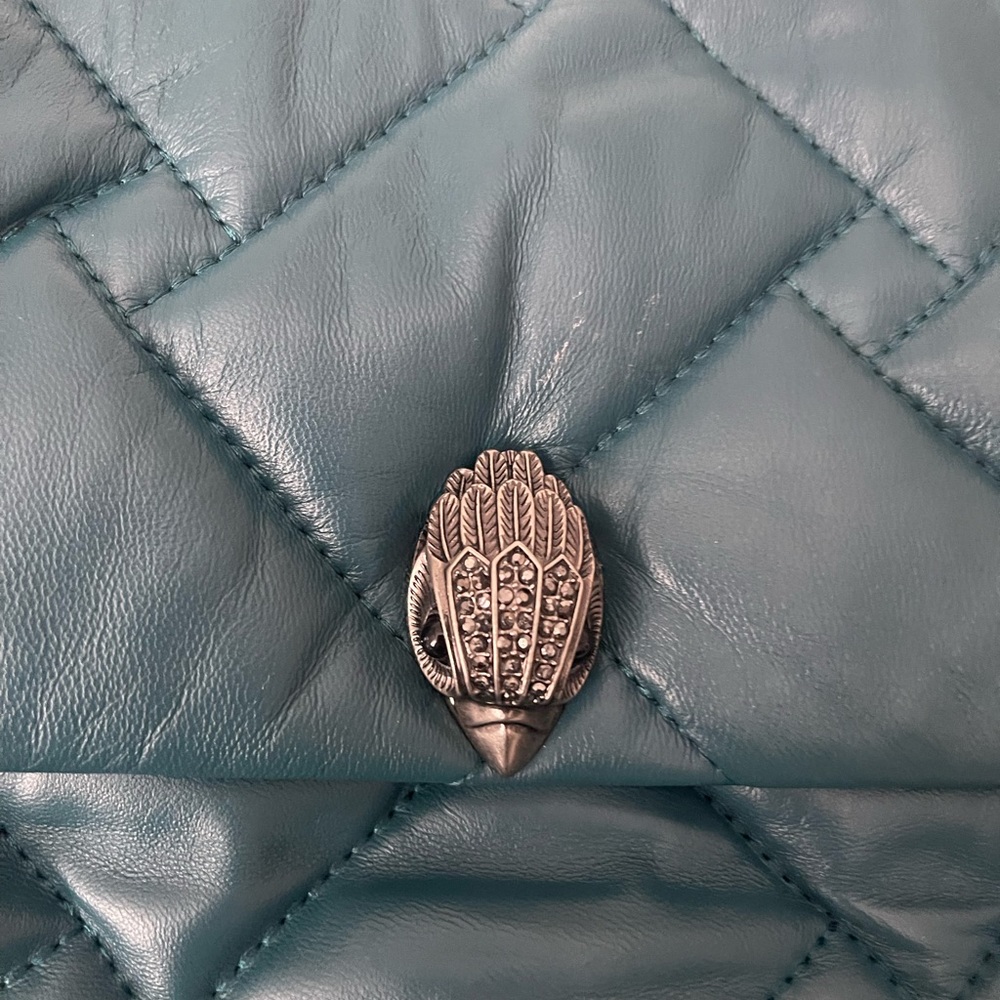 The purse has only been worn once. The color is teal.